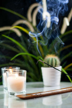 composition of incense, candles and green plants promoting relaxation and meditationの写真素材