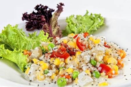 quinoa and chia salad with different vegetables on a white backgroundの写真素材