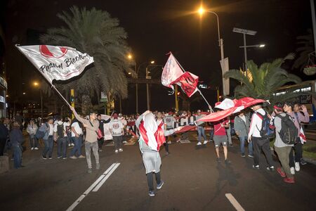 Lima, Peru - OCTOBER 12 2018: Fanaticism in Peru Peru vs. Chile Soccer. The Peruvian bar encouraging through the streets of Miraflores.のeditorial素材