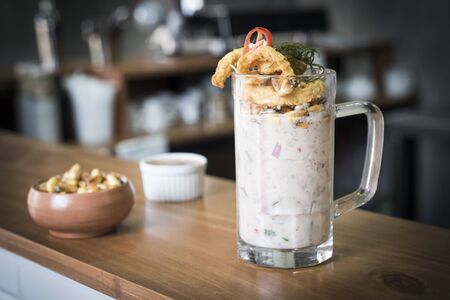 Ceviche called leche de tigre - peruvian fresh fish in a glass.の写真素材