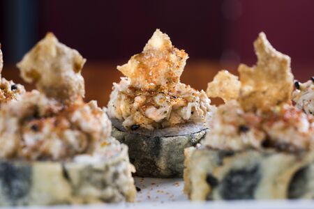 Three maki rolls in a row with salmon, eel and cucumber isolated on white background. Fresh hosomaki pieces with rice and nori. Closeup of delicious japanese food with sushi roll. niceの写真素材