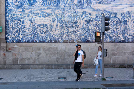 People walking in front of  traditional portuguse tiles. Green light.の写真素材