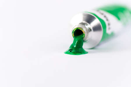 Gouache tube dripping green paint, white backgroundの写真素材