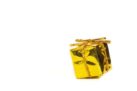 Golden Christmas present, white backgroundの写真素材