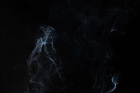 White smoke in a black backgroundの写真素材