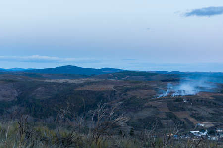 Beautiful sunset in the mountains. Wildfire and smoke.の写真素材
