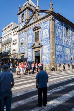 Santa Catarina Church, Porto, Portugal. Man crossing the road. Crowd on the other side of the road.のeditorial素材