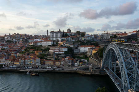 Beutiful Porto view, with Dom LuÃ­s Bridge and metro. Sunset, blue sky and clouds. Boats on the river.のeditorial素材