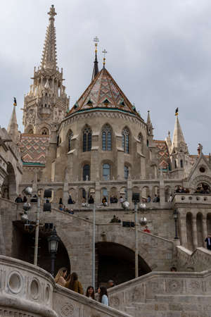 St. Matthias Church in Budapest, Hungary. Cloudy sky. Green trees.のeditorial素材