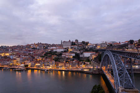 Beutiful Porto view, with Dom LuÃ­s Bridge and metro. Sunset, blue sky and clouds. Boats on the river.のeditorial素材