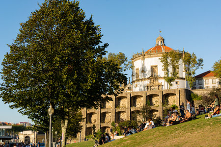 Porto, Portugal - 08/21/2019: Serra do Pilar Monastery. People sitting on the garden relaxing. Blue...
