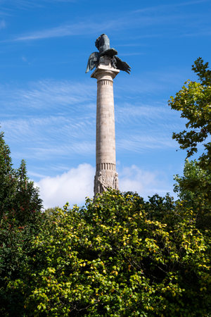 Boavista roundabout monument. Statue of a lion defeating an eagle. Trees around the monument. Blue sky. Porto, Portugal.の写真素材