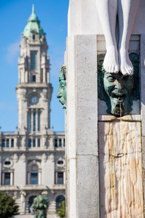 Porto city hall in the background and creepy bust in the foreground. Blue sky. Porto, Portugal.の写真素材