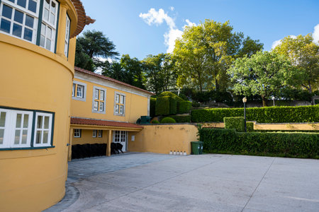 Casa do Roseiral (Roseiral House). Yellow house in the middle of a garden. Jardins do PalÃ¡cio de Cristal (Cristal palace gardens). Porto, Portugal.のeditorial素材