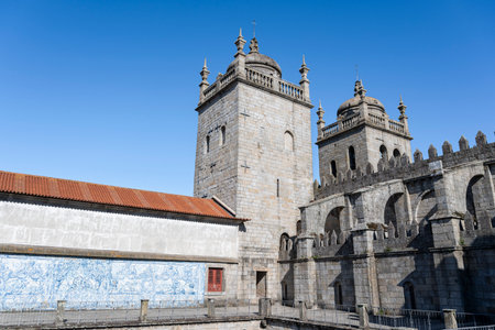 Porto cathedral seen from the inner courtyard. Building made of stone Blue sky. Porto, Portugal.の写真素材