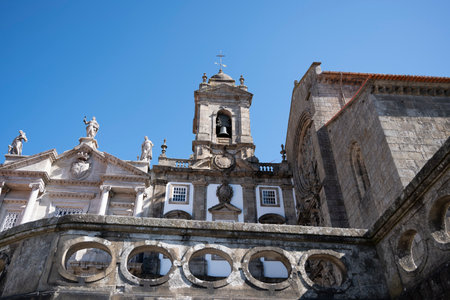 Exterior of S. Francisco church. Bell tower of a church and statues of saints on the roof. Blue sky. Porto, Portugal.の写真素材