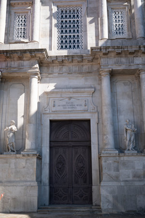 Facade of S. Francisco church. Roman style details on the rock and statues. Latin words over the door. Beautiful details on the old wood door. Porto, Portugal.の写真素材