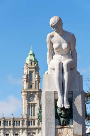 Porto city hall in the background and statue of a creepy woman in the foreground. Blue sky. Porto, Portugal.のeditorial素材