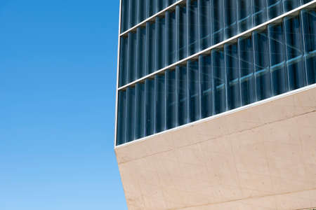 Abstract image of a modern building - modern architecture. Close up shot of the Casa da Musica do Porto (Porto Music House). Detail of the wall and windows. Blue sky. Porto, Portugal.の写真素材