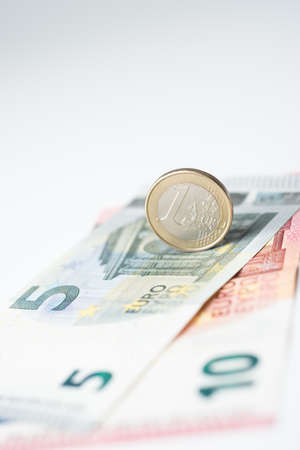 Five and ten euro note with euro coinの写真素材
