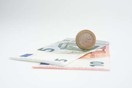 Five and ten euro note with euro coinの写真素材