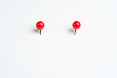 2 colored pins on a white backgroundの写真素材