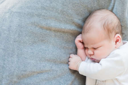 Newborn baby sleeping on blanket satisfied.の写真素材