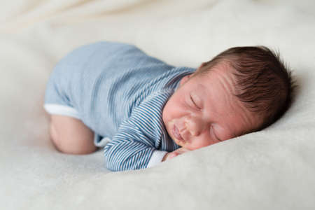 Newborn baby sleeping on blanket satisfied.の写真素材