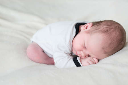 Newborn baby sleeping on blanket satisfied.の写真素材
