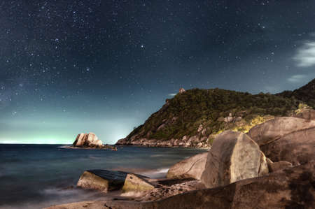 night sky sea rocks beach.の写真素材