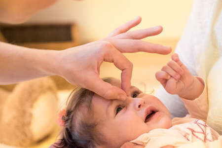 Baby at therapist physio healing massage.