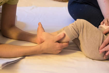 foot massage baby therapist healing.の写真素材