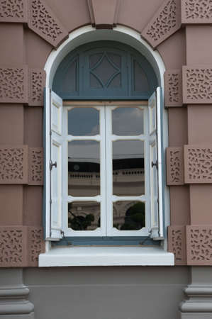 white window brown facade house.