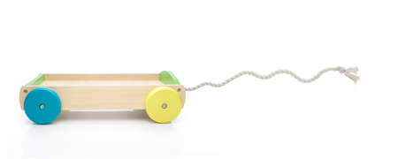 Toy carriage with rope against white background. Funny concept of tractionの写真素材