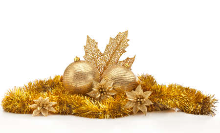 Golden Christmas center against white background. Christmas balls, golden garland and leaf, flowers and spangles.の写真素材