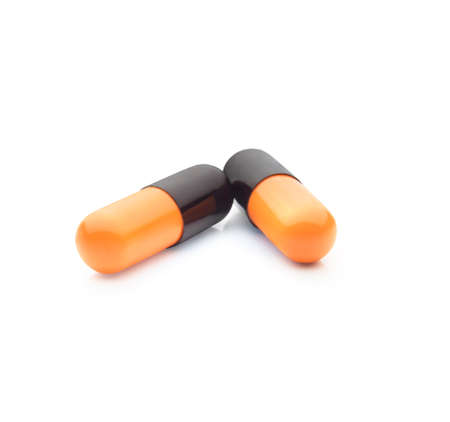 Two colorful pills isolated on white background