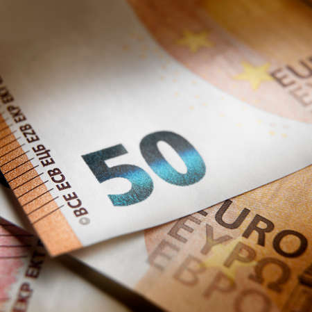 Shallow focus on close up view of a fifty euros banknote with a light effect