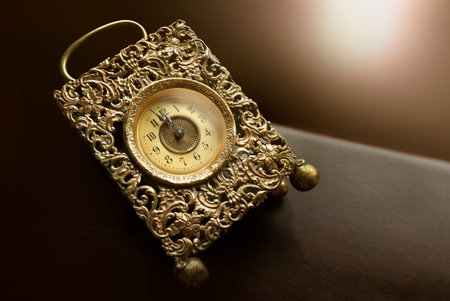 Countdown to midnight eve at an ancient golden vintage clock. Light effect background. Copy space...