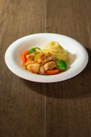 Tomato sauce in angel hair paste with mixed vegetables, chickenの写真素材