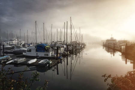 Sails in the fog. Spring foggy morning in Vancouver, Canadaの写真素材