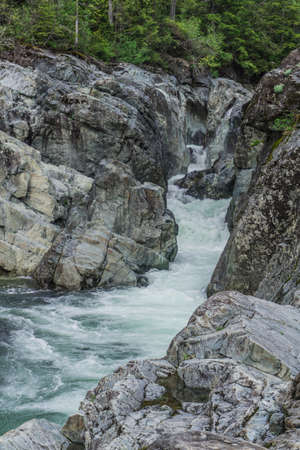 The beauty of Wally Creek pullout. Forest, wild river, rocks and trees on Vancouver Island in Canadaの写真素材
