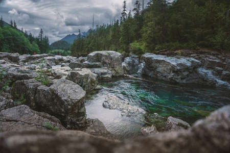 The beauty of Wally Creek pullout. Forest, wild river, rocks and trees on Vancouver Island in Canadaの写真素材