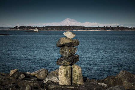 Inukshuk and Mt Baker far away. Photo taken from popular Oak Bay marina in Victoria