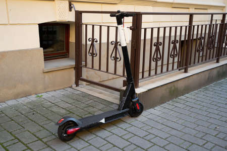 Electric scooter to rent left on brick pavementの写真素材