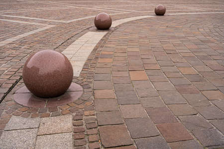 polished stone balls on cobblestone pavementの写真素材