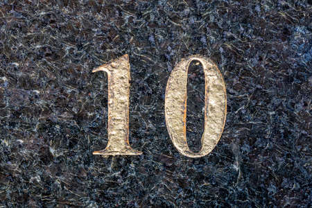 Number 10 embossed on an old rusty metal background. Toned.の写真素材