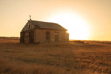 A small thatched hut on a field.の写真素材
