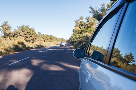 car traveling at a speed in the nature on the asphalt road.の写真素材