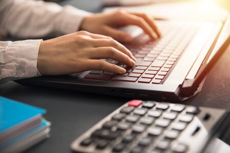 man hand  keyboard and calculator on deskの写真素材