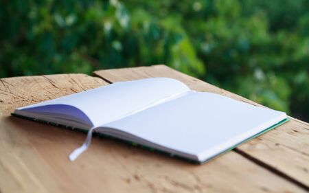 Close-up view of an empty notebook on wooden tableの写真素材